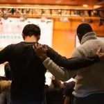 two men praying in a church