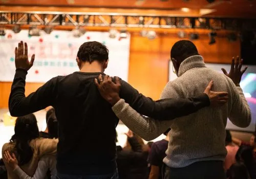 two men praying in a church