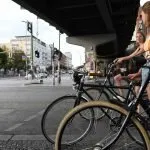 girls riding their bikes on the streets of berlin