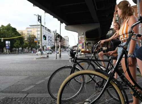 girls riding their bikes on the streets of berlin