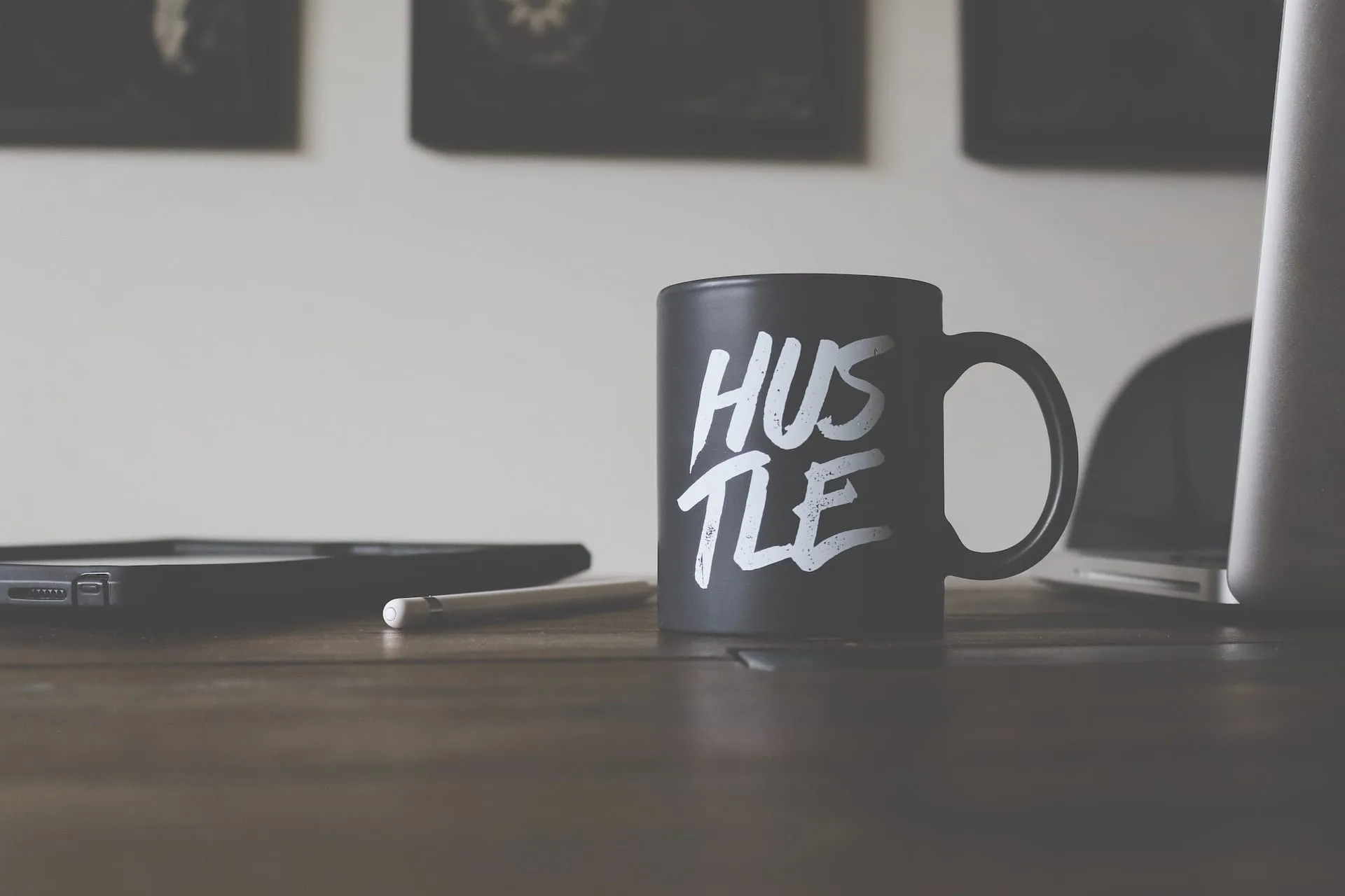 a black mug with hustle written on it