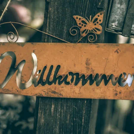 german word wilkommen written on a sign