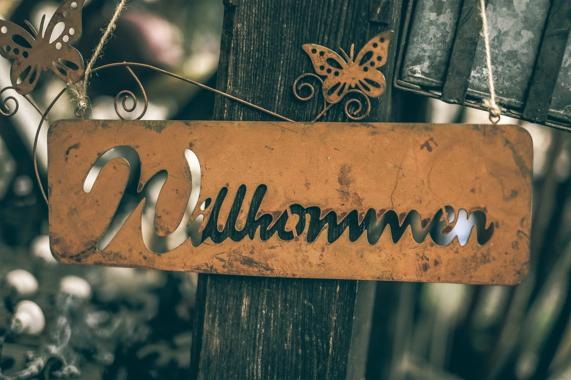 german word wilkommen written on a sign
